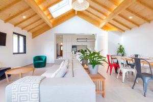 a living room with a large couch and a table at La Balzac in Dijon