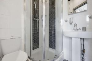a bathroom with a shower and a toilet and a sink at The Forest- Blackwood in Cambridge