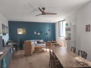 a living room with a couch and a table at Sur la Draille in Le Vigan