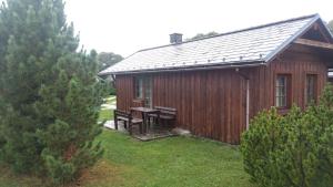 a wooden cabin with a picnic table in front of it at Chata 412 Tatralandia in Liptovský Mikuláš