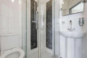 a bathroom with a toilet and a sink and a shower at The Forest- Silverwood in Cambridge