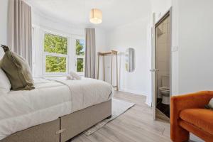 a bedroom with a bed and a window and a bathroom at The Forest- Silverwood in Cambridge