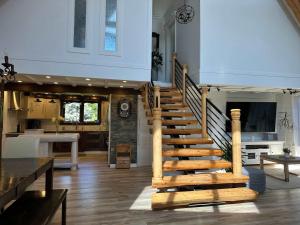 a staircase in a house with a kitchen and a living room at Spa Swimming Pool & Nature - Chalet rang 3 in Roberval