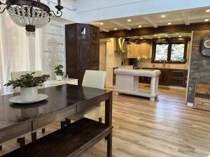 a living room with a dining table and a kitchen at Spa Swimming Pool & Nature - Chalet rang 3 in Roberval
