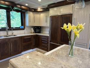 a kitchen with a vase of yellow flowers on a counter at Spa Swimming Pool & Nature - Chalet rang 3 in Roberval