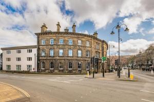 an old brick building on a city street at Crescent Inn by Maison Pierre in Ilkley