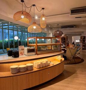 a restaurant with a counter with plates on it at 丰居中壢 Via Hotel Zhongli in Zhongli +35 photos
