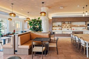 a restaurant with a couch and tables and chairs at B&B HOTEL Cieza in Cieza