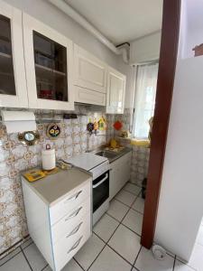 a kitchen with white cabinets and a stove top oven at VARIE STRUTTURE Queste strutture NON FORNISCE lenzuola da letto e asciugamani in Lido Adriano