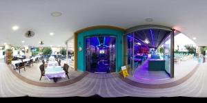 a restaurant with purple walls and tables and chairs at Yade Luxe Hotel in Marmaris +113 photos