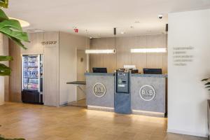 an office lobby with a cash register and a drink counter at B&B HOTEL Cieza in Cieza