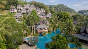 an aerial view of a resort with blue water at Thavorn Beach Village Resort & Spa Phuket in Kamala Beach