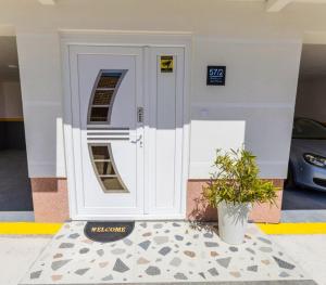 a front door of a building with a potted plant at Bay Horizon View in Igalo