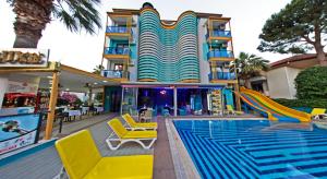 a hotel with a slide next to a swimming pool at Yade Luxe Hotel in Marmaris