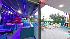 a restaurant with purple lighting and tables and chairs at Yade Luxe Hotel in Marmaris
