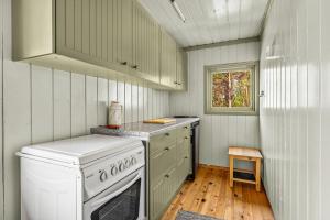a small kitchen with a stove and a sink at Panoramic View - near Pulpit Rock in Strand
