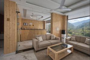 a living room with a couch and a table at Hotel Classic Crown - #Scenic mountain view #open terrace #guest preferred #best selling hotel in Mussoorie in Mussoorie
