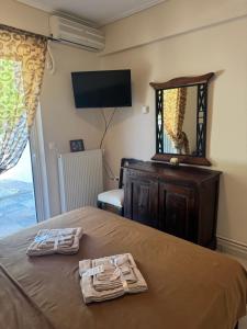 a bedroom with a bed with two towels on it at GK23 Sea View House in Anavyssos