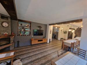 a living room with a table and a dining room at Wild River Cottage in Lissa