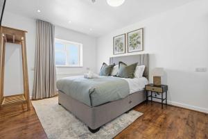 a bedroom with a large bed and a window at The Forest- Elderwood in Cambridge