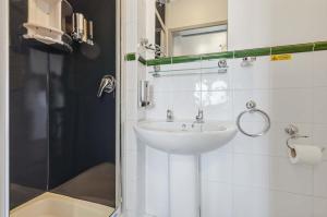 a bathroom with a sink and a shower at The Forest- Elderwood in Cambridge