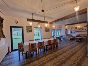 a dining room and living room with a table and chairs at Wild River Cottage in Lissa