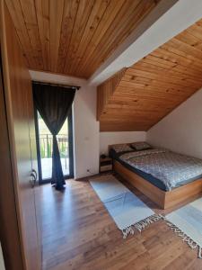 a bedroom with a bed and a large window at Wild River Cottage in Lissa