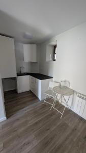 a kitchen with a table and a table and a table and chairs at Casa rural A Fonte, Balneario Histórico de Cortegada in Cortegada