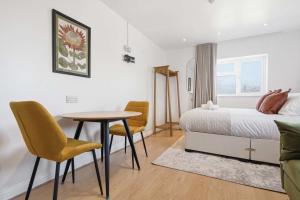a bedroom with a bed and a table and chairs at The Forest-Wildwood in Cambridge