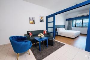 a living room with a couch and a bed at 103 Hotel by manatidur in Kuala Lumpur +17 photos