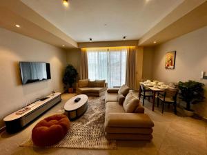 a living room with a couch and a table at Masaki Cozy Stay in Dar es Salaam