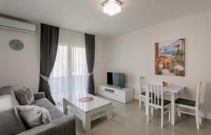 a living room with a couch and a table at Apartmani Coka in Sušćepan