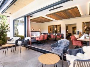 a lobby of a hotel with chairs and tables at Hotel Goldene Rose in Reutte