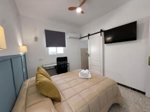 a bedroom with a large bed and a couch at Casita Machado in Úbeda
