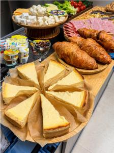 a table filled with bread and pastries and other foods at ROCAS Hotel in Orhei