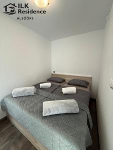 a bedroom with a bed with two pillows on it at ILK Residence 1 in Alsóörs +15 photos