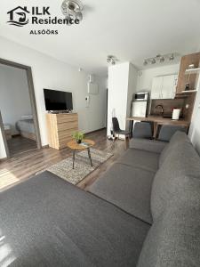 a living room with a couch and a table at ILK Residence 1 in Alsóörs