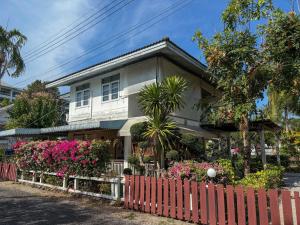 a house with flowers in front of it at The Rich Instantly Home in Sathani Huai Yang