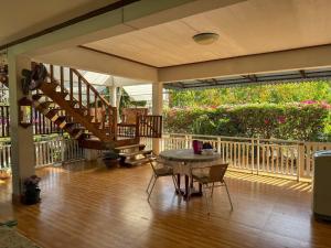 a patio with a table and a staircase in a house at The Rich Instantly Home in Sathani Huai Yang