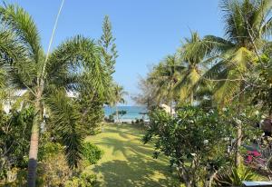a view of the beach from a resort with palm trees at The Rich Instantly Home in Sathani Huai Yang +7 photos