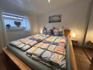 a bedroom with a large bed with a quilt on it at Ferienwohnung Nestblick in Weilburg