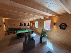 a living room with a pool table and a couch at Bauernhuus 6 in Fehmarn