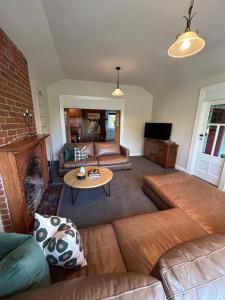 a living room with a couch and a table at Amberley Lodge in Amberley