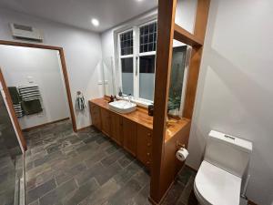 a bathroom with a sink and a mirror at Amberley Lodge in Amberley +19 photos