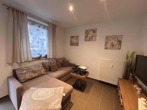 a living room with a couch and a television at Ferienwohnung Hofblick in Weilburg