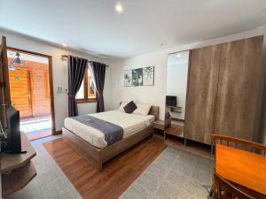 a bedroom with a bed and a tv in it at Sun Nova Home Phu Quoc in Phú Quốc