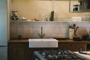 a kitchen counter with a sink and a stove at 18Th-Century Stone House By River In Romagna in Sarsina