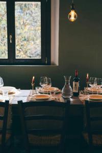 a table with glasses and bottles of wine on it at 18Th-Century Stone House By River In Romagna in Sarsina