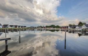 a large body of water with houses and a cloudy sky at Haus Hallon in Wandlitz