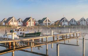 a dock with boats in the water near houses at Haus Hallon in Wandlitz +16 photos